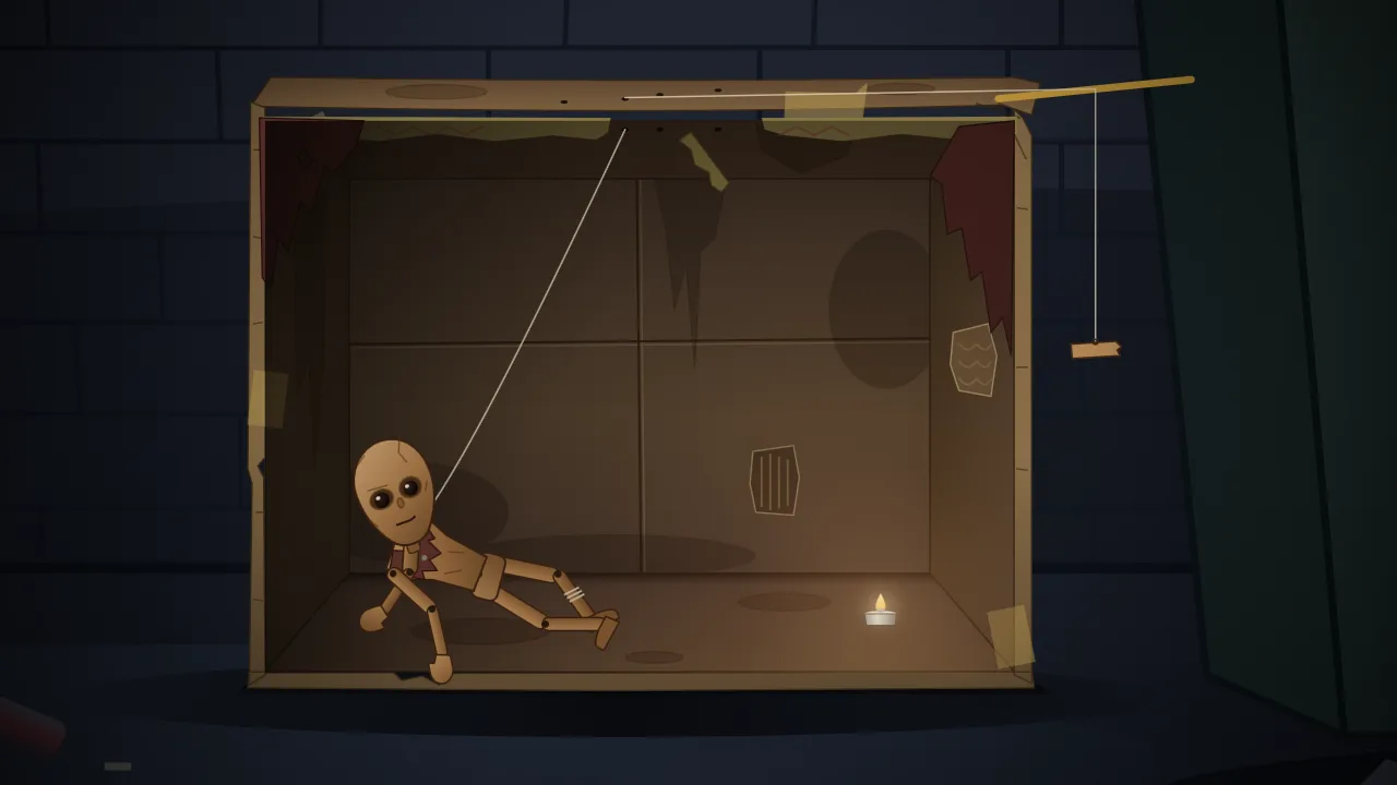 A wooden marionette lies in a heap inside a weathered cardboard box lit by a tea light, one string rising to a grip